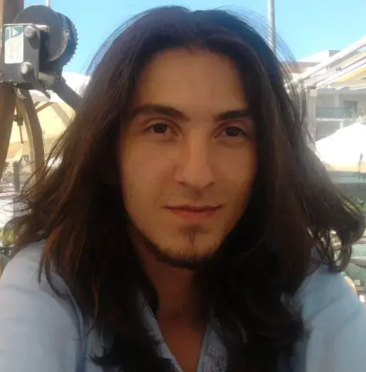 Asilcan Toper's profile image: a man in his mid-20s with long hair and a goatee, wearing a blue t-shirt.