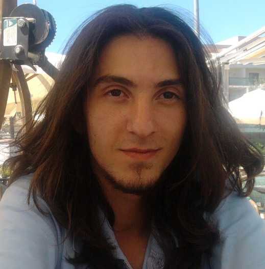 Asilcan Toper's profile image: a man in his mid-20s with long hair and a goatee, wearing a blue t-shirt.